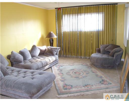 61 Winthrop Road Edison, NJ 08817 - Photo 3 of 6 a living room with furniture and a large window