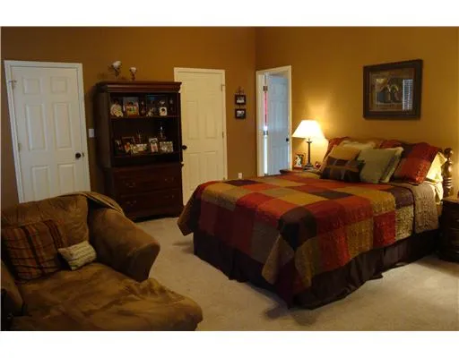 a bedroom with a bed and wall painting