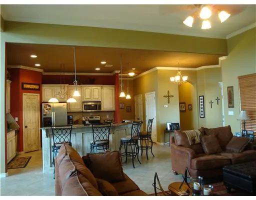 a living room with lots of furniture and kitchen view