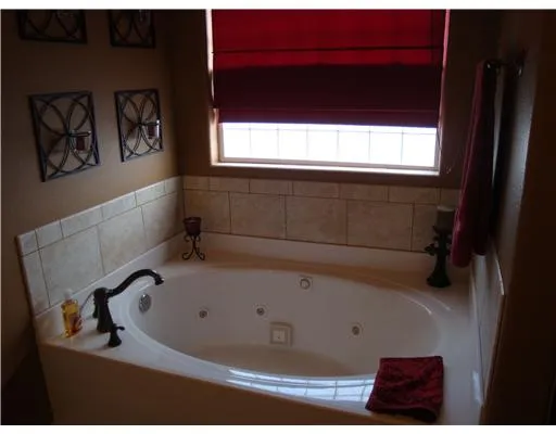 a bathroom with a bathtub and a window