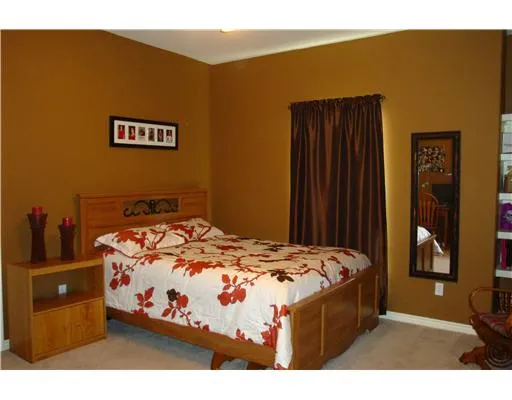 a bedroom with a bed and a night stand