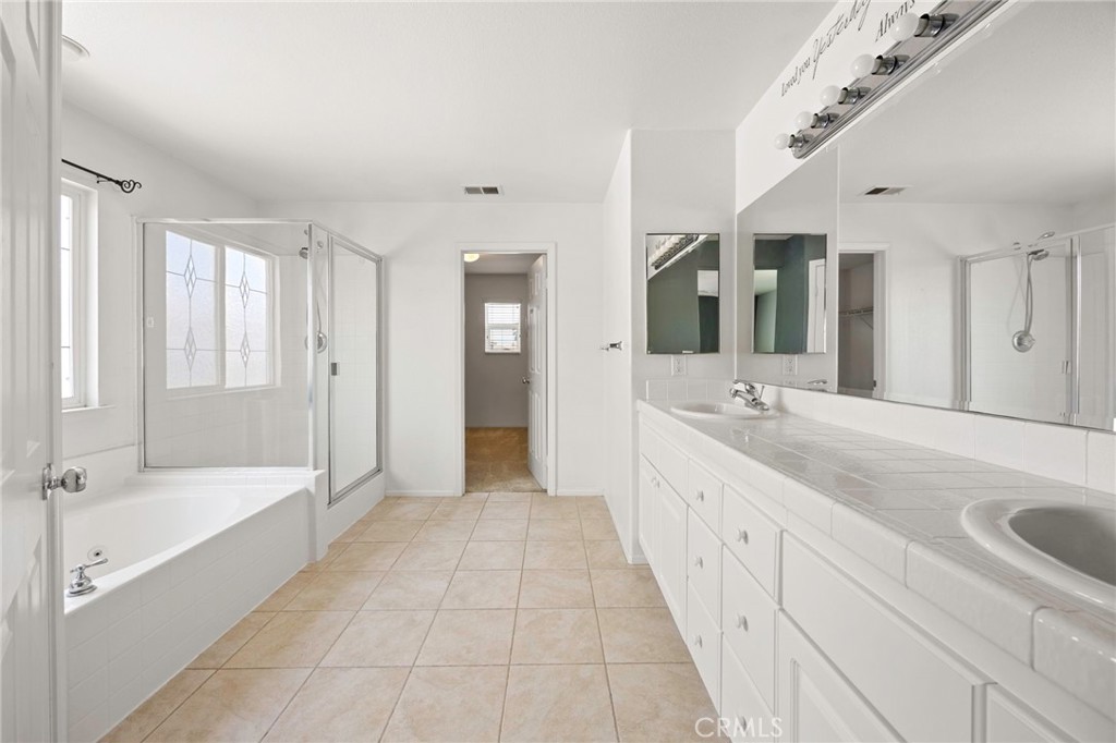 151 Ropango Way Hemet, CA 92545 - Photo 20 of 28 a spacious bathroom with a tub sink shower and mirror