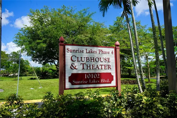a sign that is sitting on a lush green field