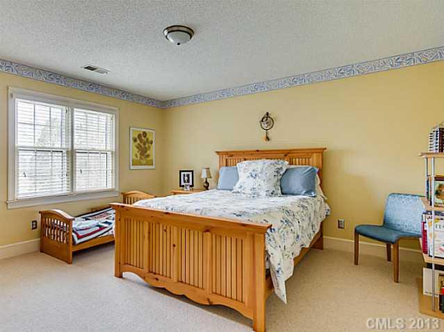 7227 Alexander Road Charlotte, NC 28270 - Photo 14 of 16 a bedroom with a bed and a window