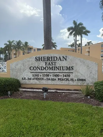 a front view of a building with a garden