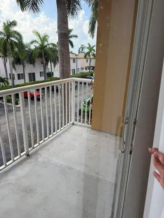 a view of balcony with a palm tree