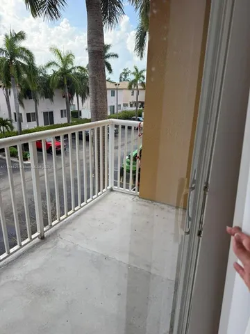 a view of balcony with a palm tree