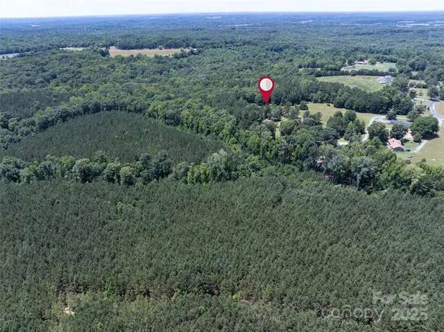 an aerial view of a house and mountain view