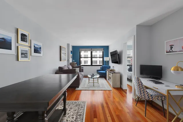 a living room with furniture a flat screen tv and a fireplace