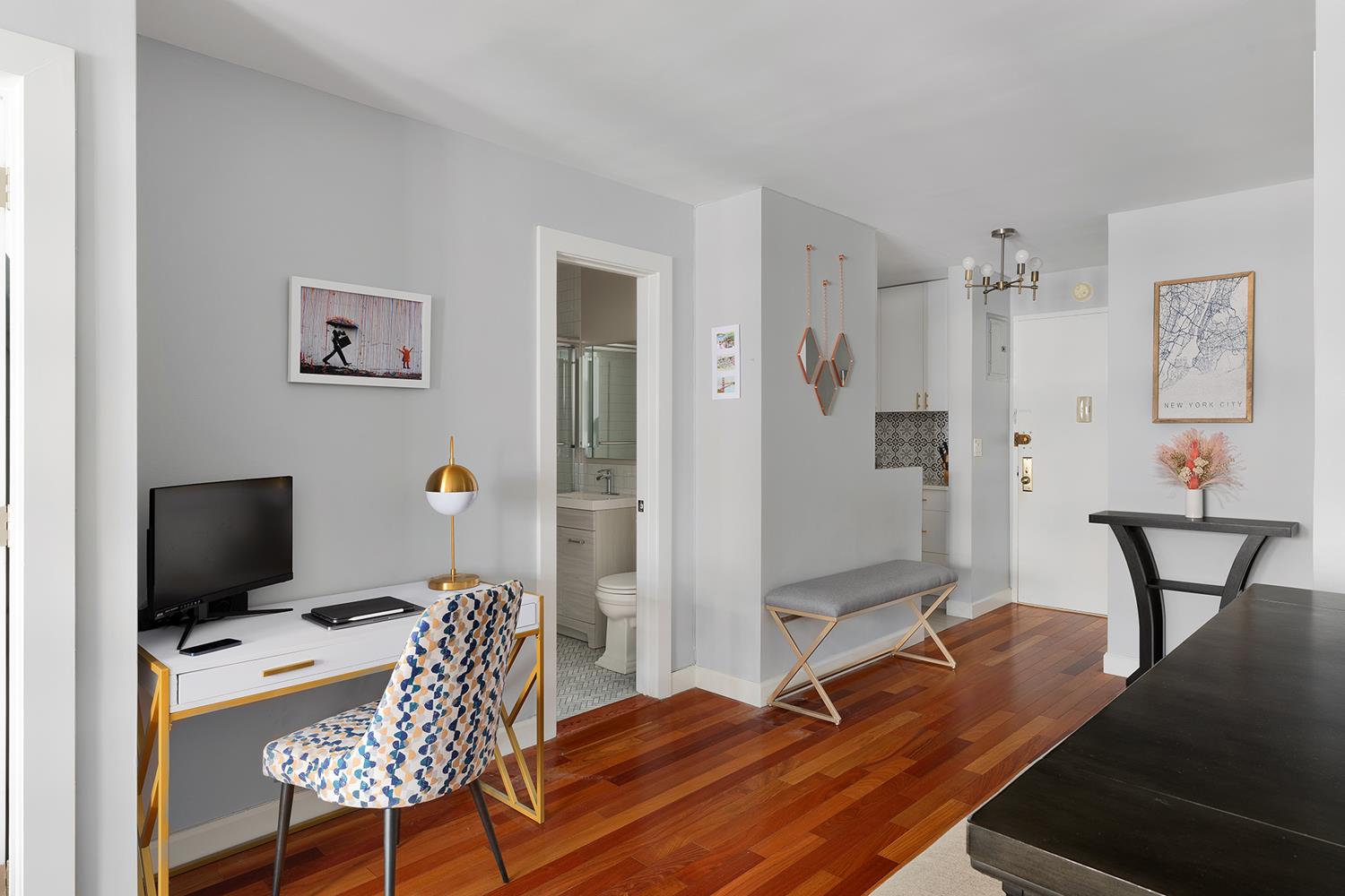 200 East 24th Street, Unit 804 Manhattan, NY 10010 - Photo 2 of 7 a bedroom with a bed and a table