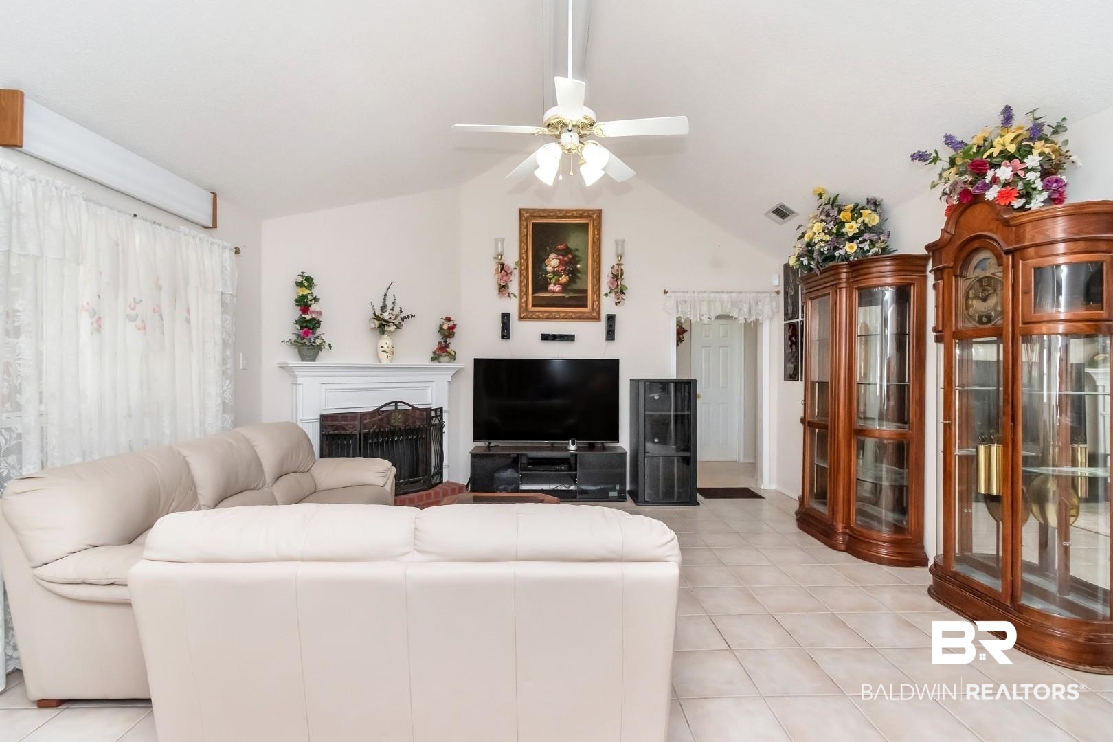 8221 Woodbend Drive Semmes, AL 36575 - Photo 7 of 35 Tiled living room with vaulted ceiling and ceiling fan