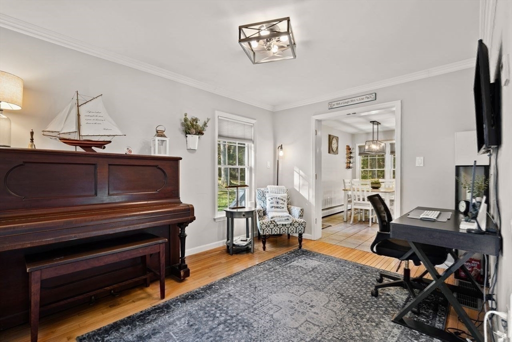29 Charlotte Road Ipswich, MA 01938 - Photo 13 of 42 a living room with furniture a piano and a flat screen tv