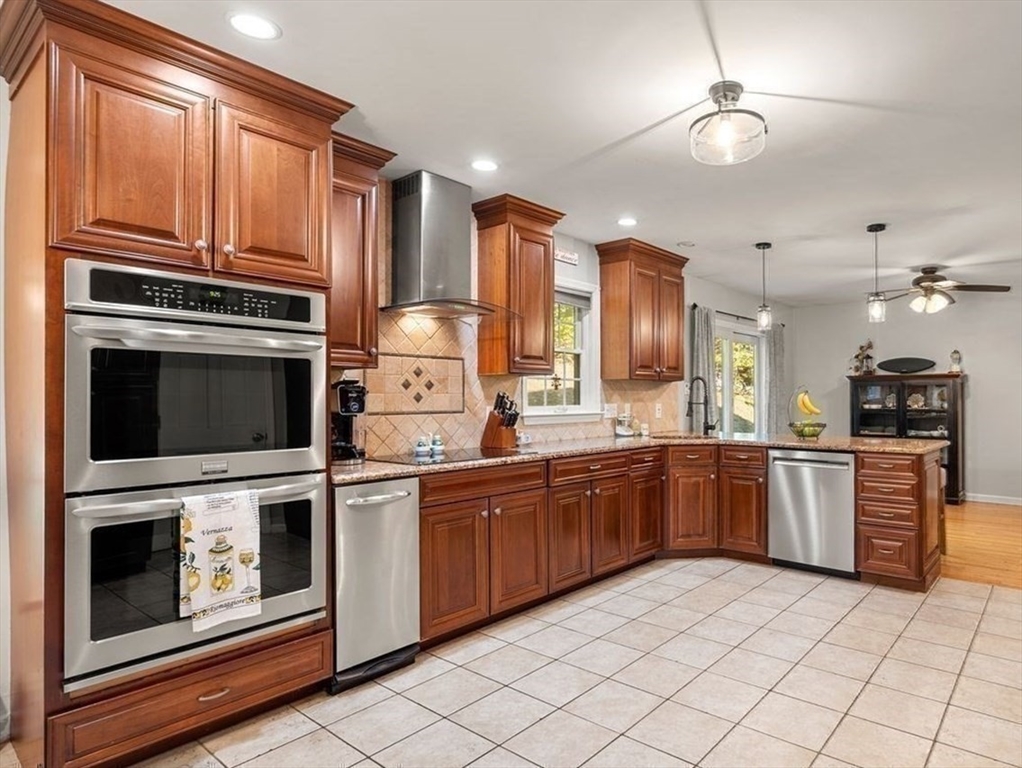 29 Charlotte Road Ipswich, MA 01938 - Photo 6 of 42 a kitchen with stainless steel appliances granite countertop a stove top oven a sink dishwasher and a microwave oven
