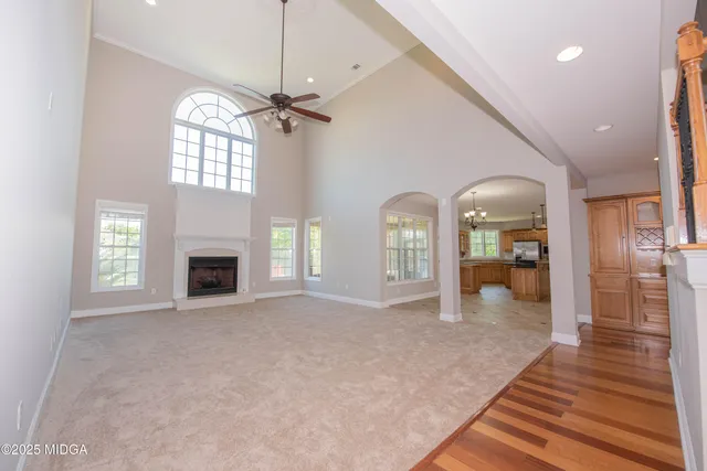 a kitchen with stainless steel appliances granite countertop a refrigerator a sink a stove and island