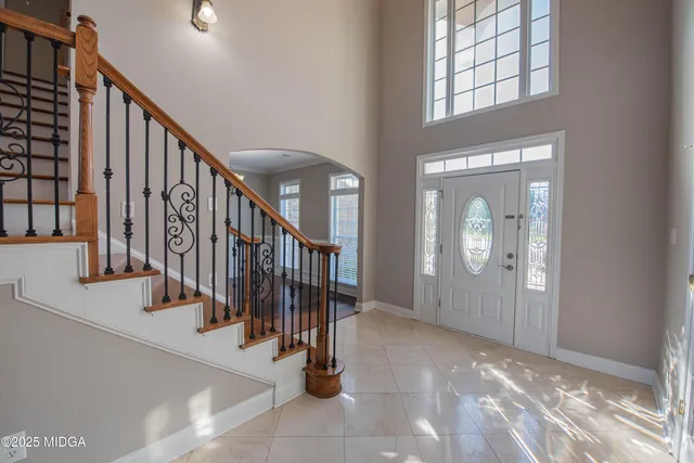 a view of a livingroom with wooden floor and stairs