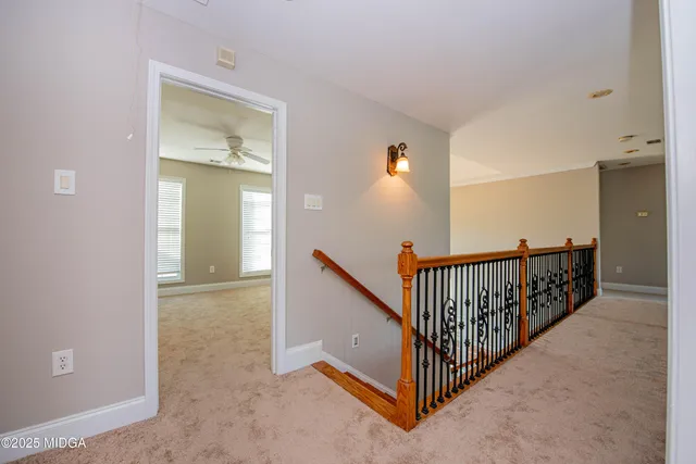 a spacious bathroom with a granite countertop sink a mirror and a shower