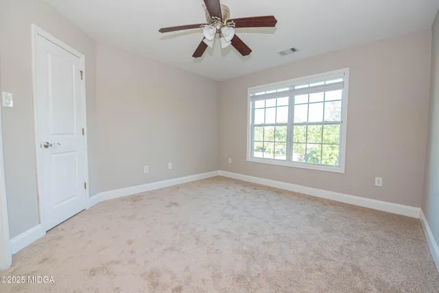 a kitchen with granite countertop a stove a sink and a refrigerator