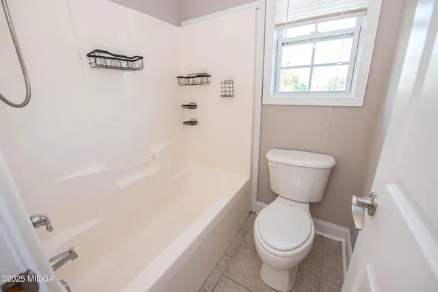 a balcony with wooden floor and fence