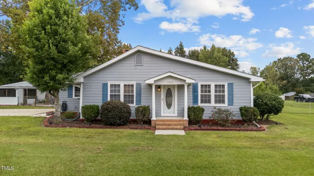 a view of a house with a yard and plants