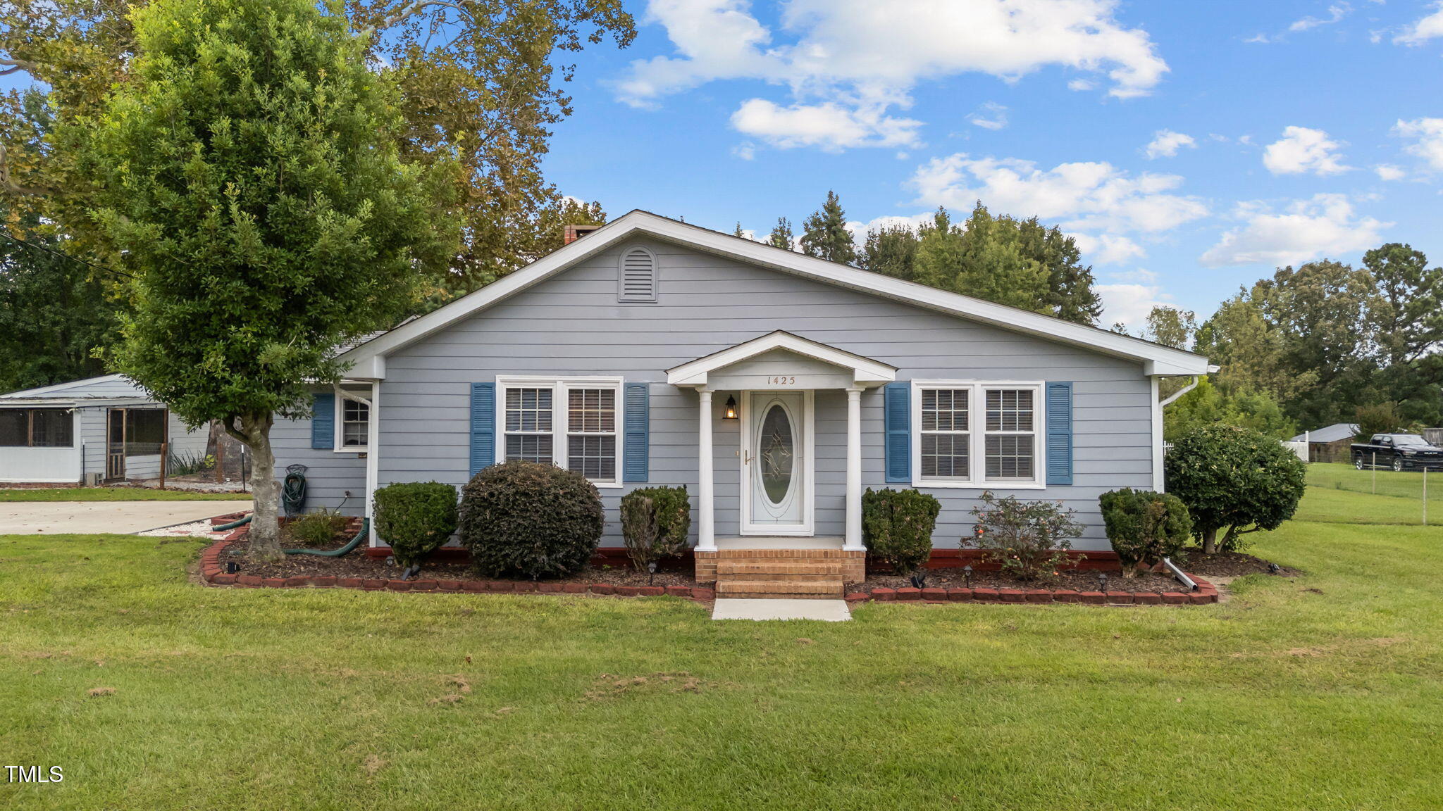 a view of a house with a yard and plants