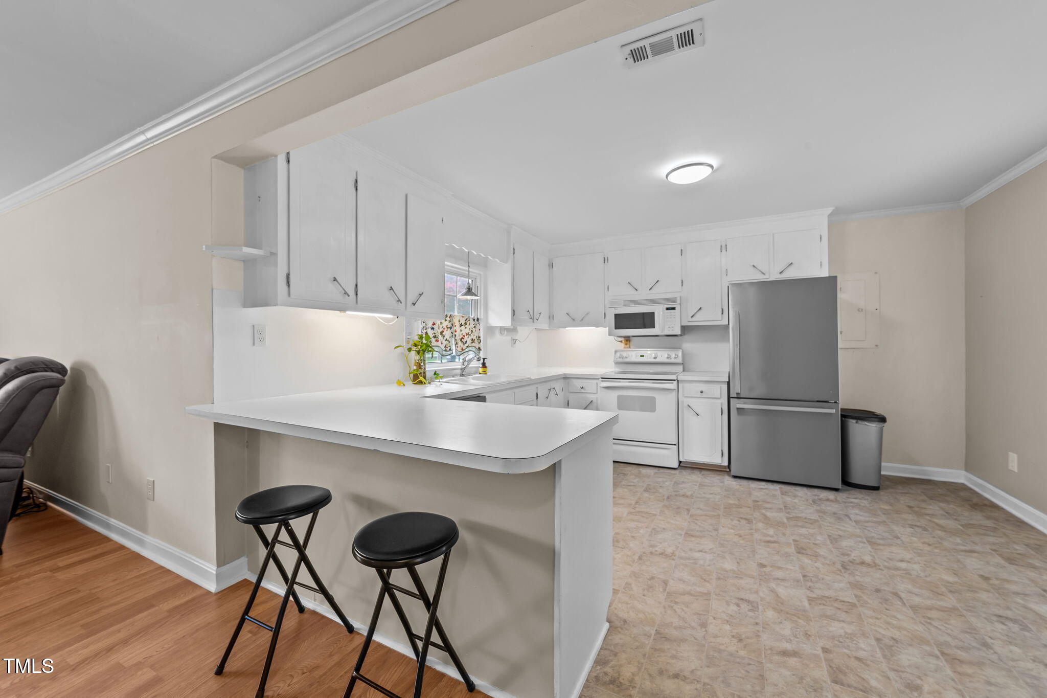 1425 Langdon Road Angier, NC 27501 - Photo 13 of 55 a kitchen with a table chairs refrigerator and cabinets