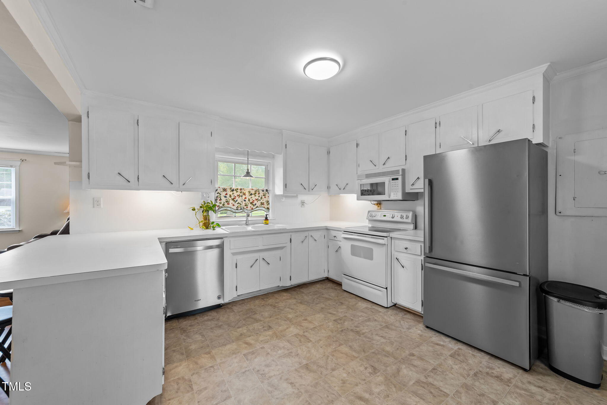 1425 Langdon Road Angier, NC 27501 - Photo 14 of 55 a kitchen with white cabinets and stainless steel appliances