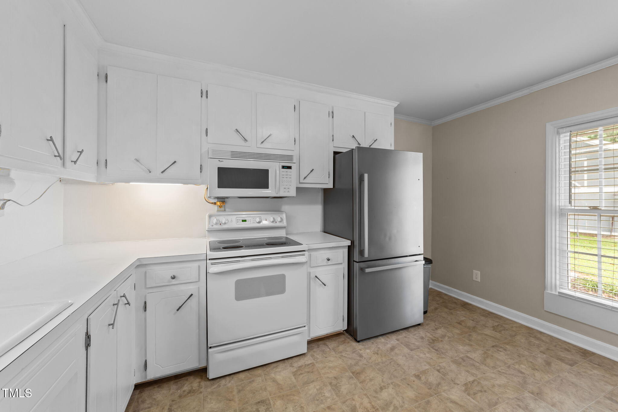 1425 Langdon Road Angier, NC 27501 - Photo 20 of 55 a kitchen with stainless steel appliances white cabinets and a refrigerator