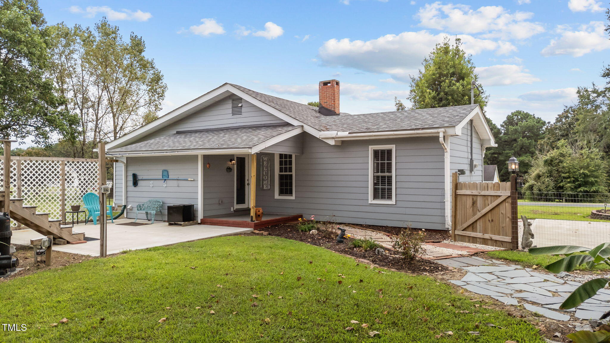 1425 Langdon Road Angier, NC 27501 - Photo 28 of 55 a view of a house with a yard and floor to ceiling window