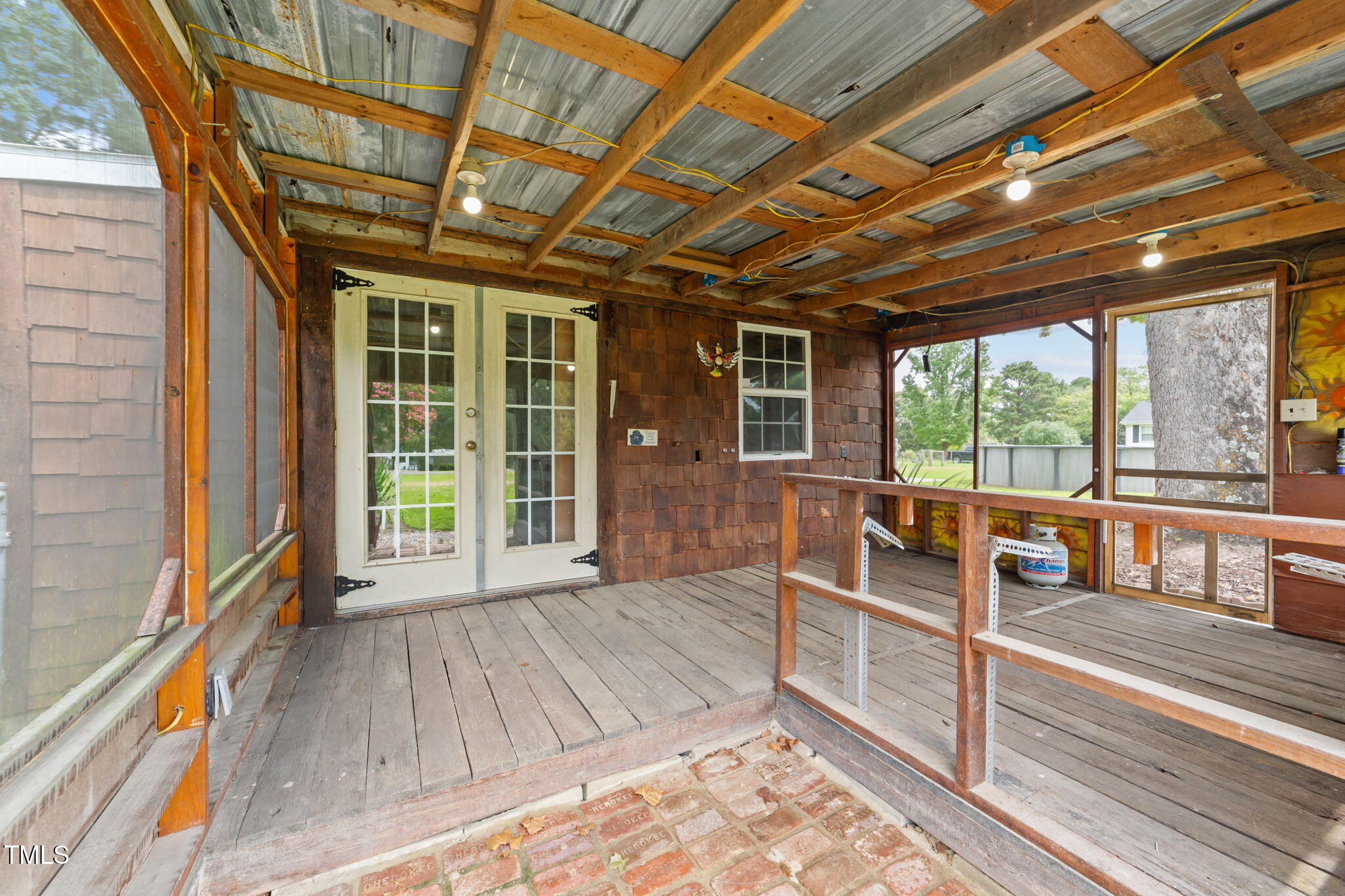 1425 Langdon Road Angier, NC 27501 - Photo 34 of 55 a view of a porch with wooden floor and roof with a barbeque