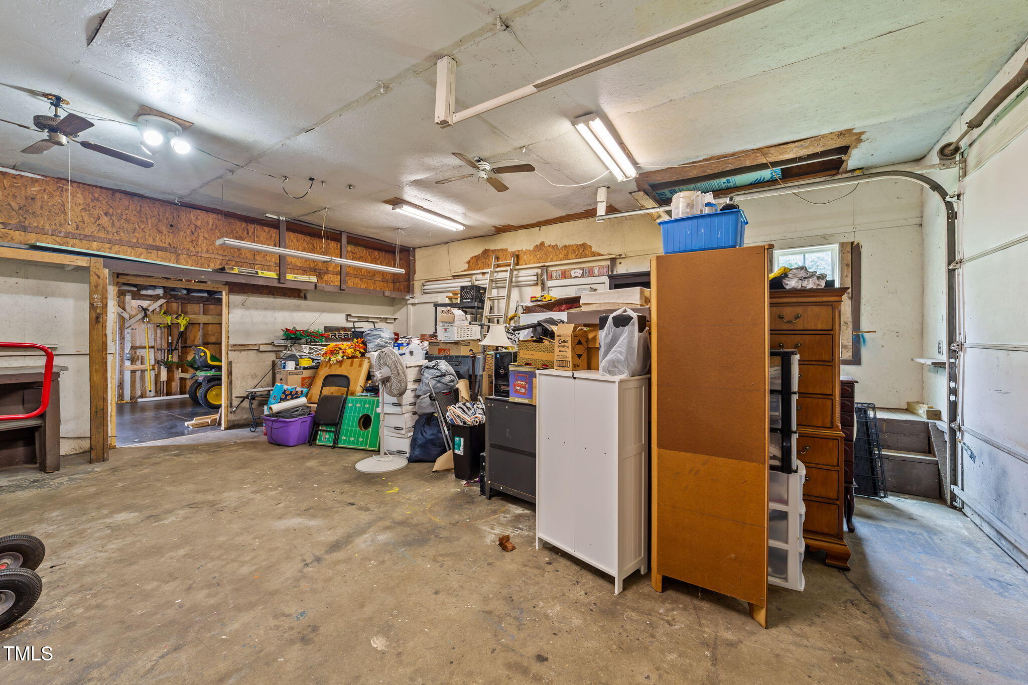 1425 Langdon Road Angier, NC 27501 - Photo 38 of 55 a view of a storage room with a refrigerator and storage