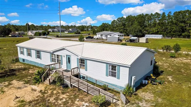 a aerial view of a house with a yard