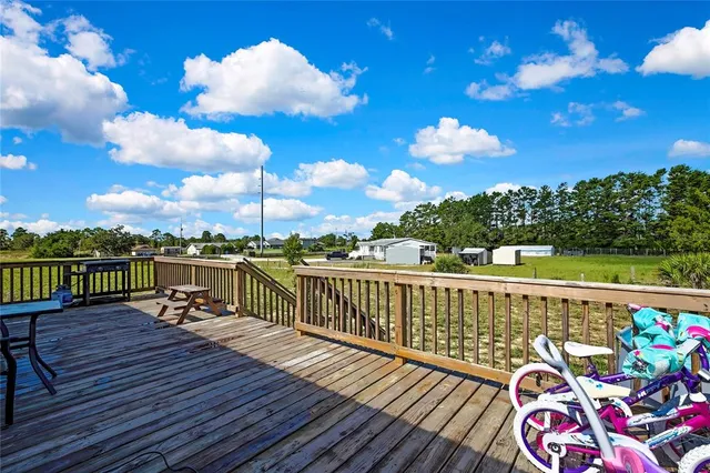 a view of a balcony with wooden floor and seating space