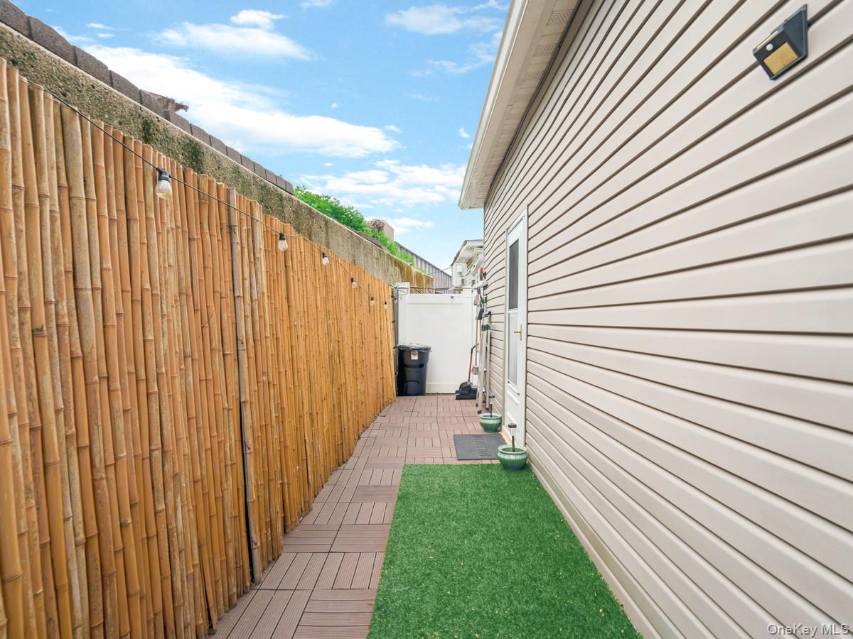 218-12 141st Road Queens, NY 11413 - Photo 14 of 14 a view of a backyard with wooden fence