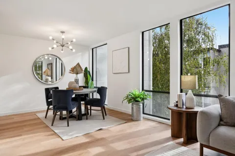 a view of a dining room with furniture window and wooden floor