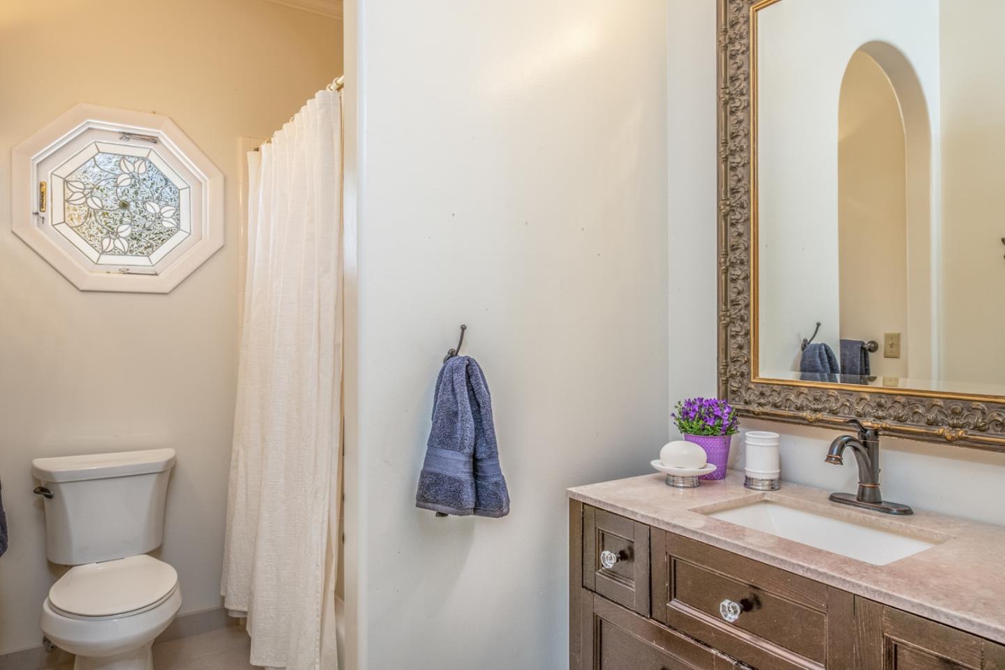 3602 Eastfield Road Carmel, CA 93923 - Photo 13 of 27 a bathroom with a granite countertop toilet sink and mirror