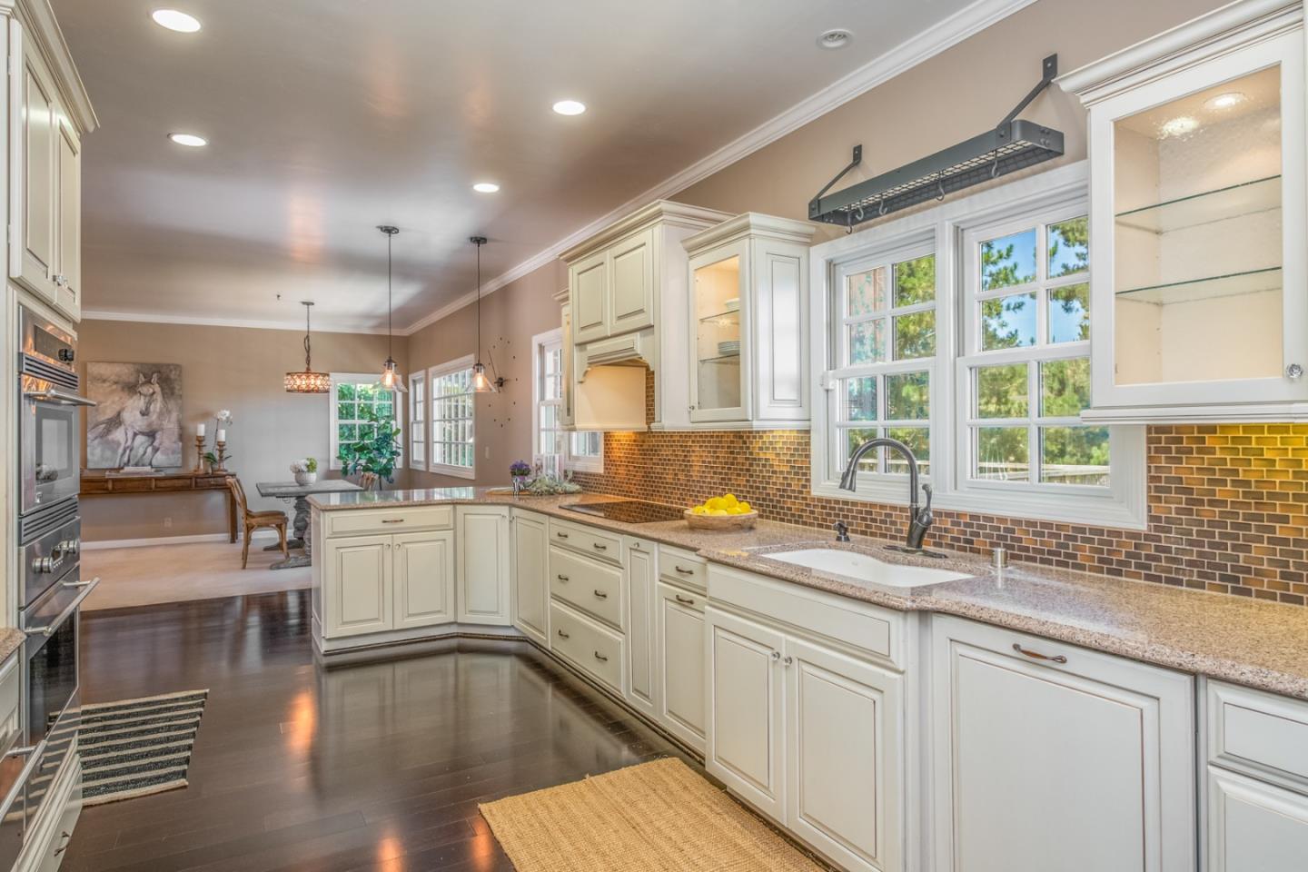 3602 Eastfield Road Carmel, CA 93923 - Photo 9 of 27 a kitchen with stainless steel appliances granite countertop a stove a sink and white cabinets