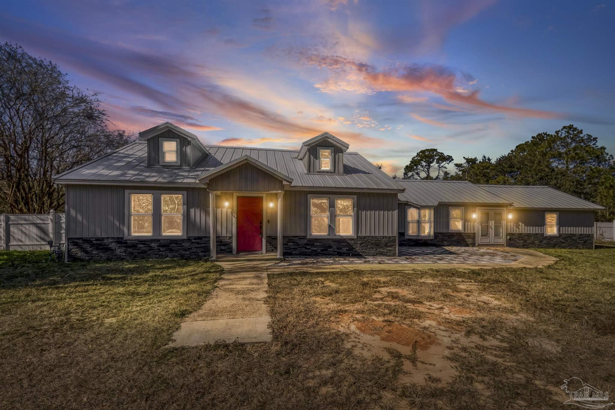 4881 Calvin Drive Milton, FL 32583 - Photo 22 of 24 a front view of a house with a yard