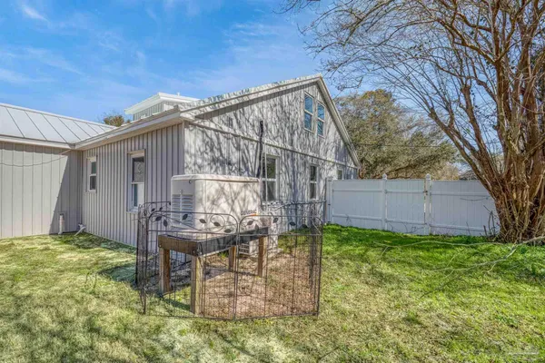 a view of a chair and table in backyard of the house