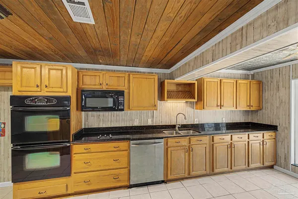 a kitchen with granite countertop stainless steel appliances and cabinets