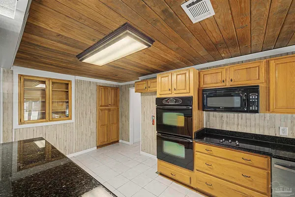 a kitchen with stainless steel appliances granite countertop a stove and a microwave