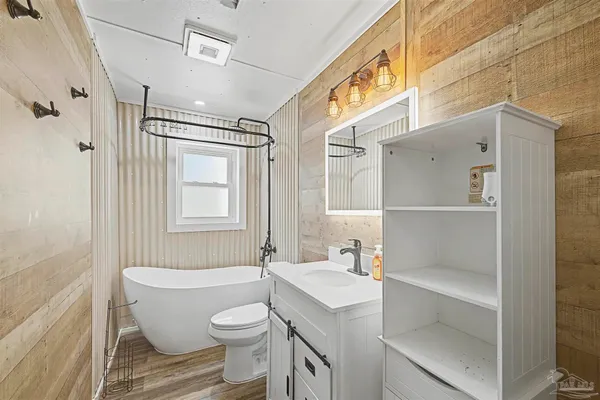 a bathroom with a sink toilet tub and shower
