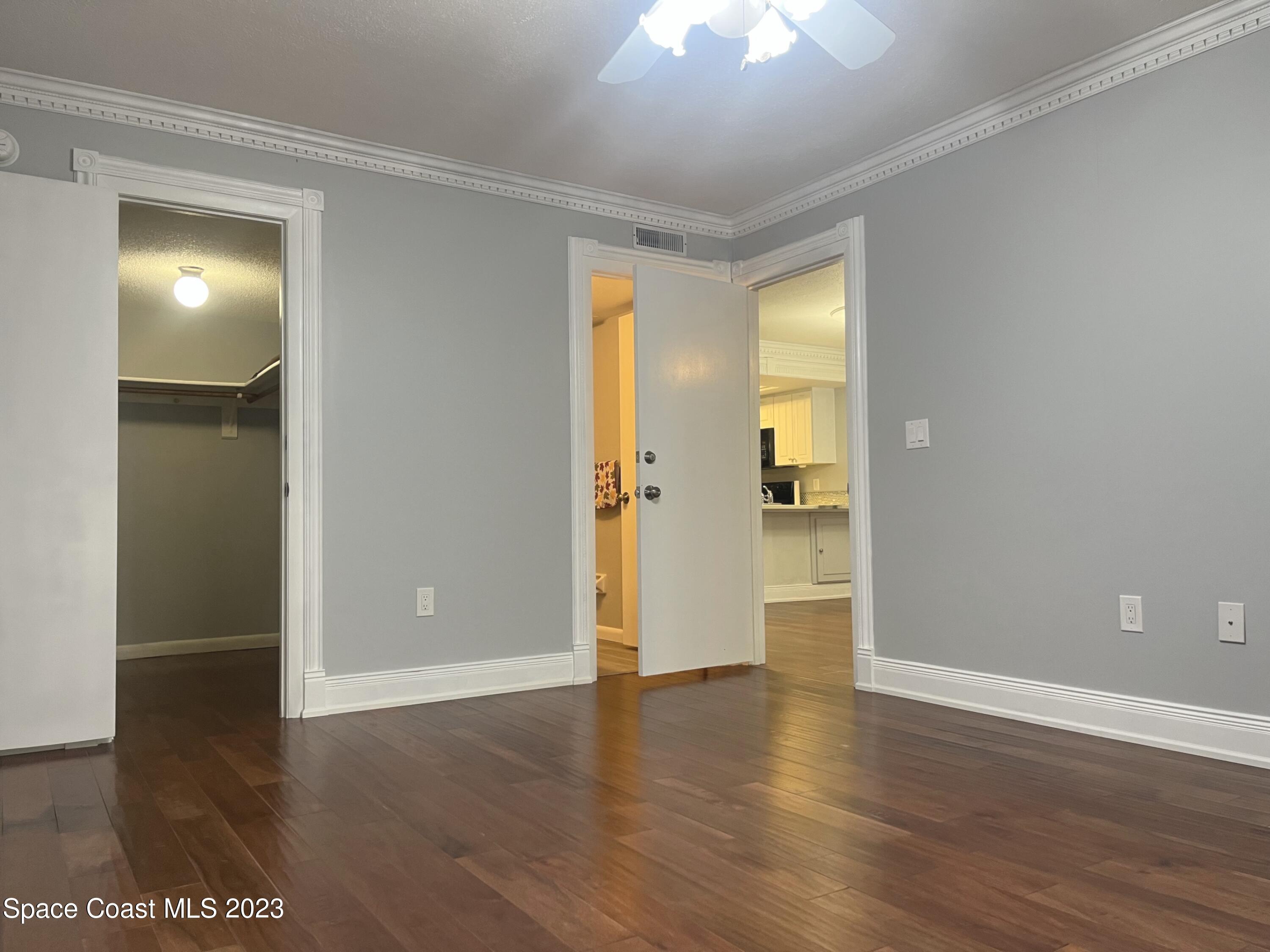 1675 South Fiske Boulevard, Unit 155 Rockledge, FL 32955 - Photo 12 of 24 wooden floor in an empty room with a window