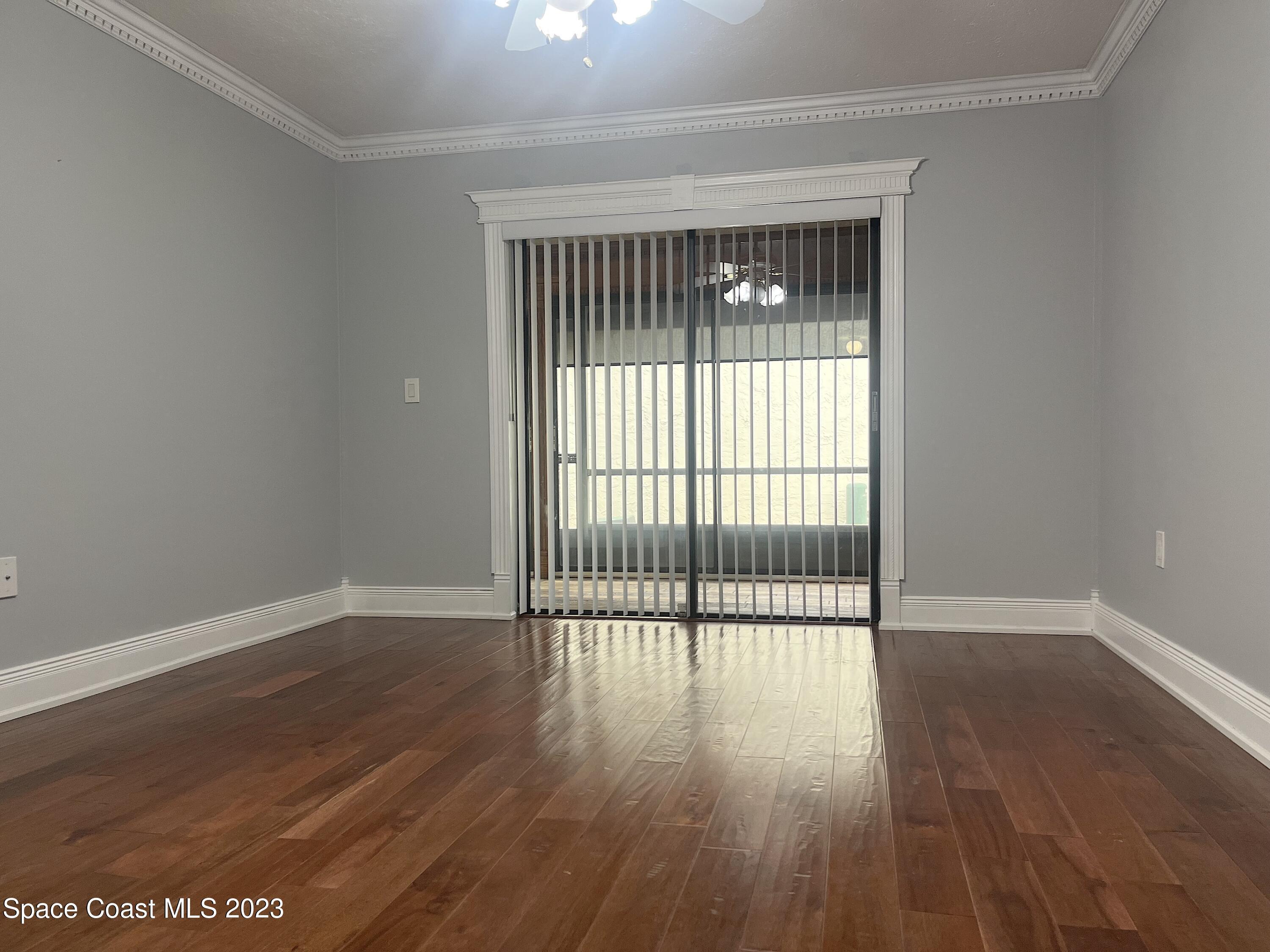 1675 South Fiske Boulevard, Unit 155 Rockledge, FL 32955 - Photo 13 of 24 wooden floor in an empty room with a window