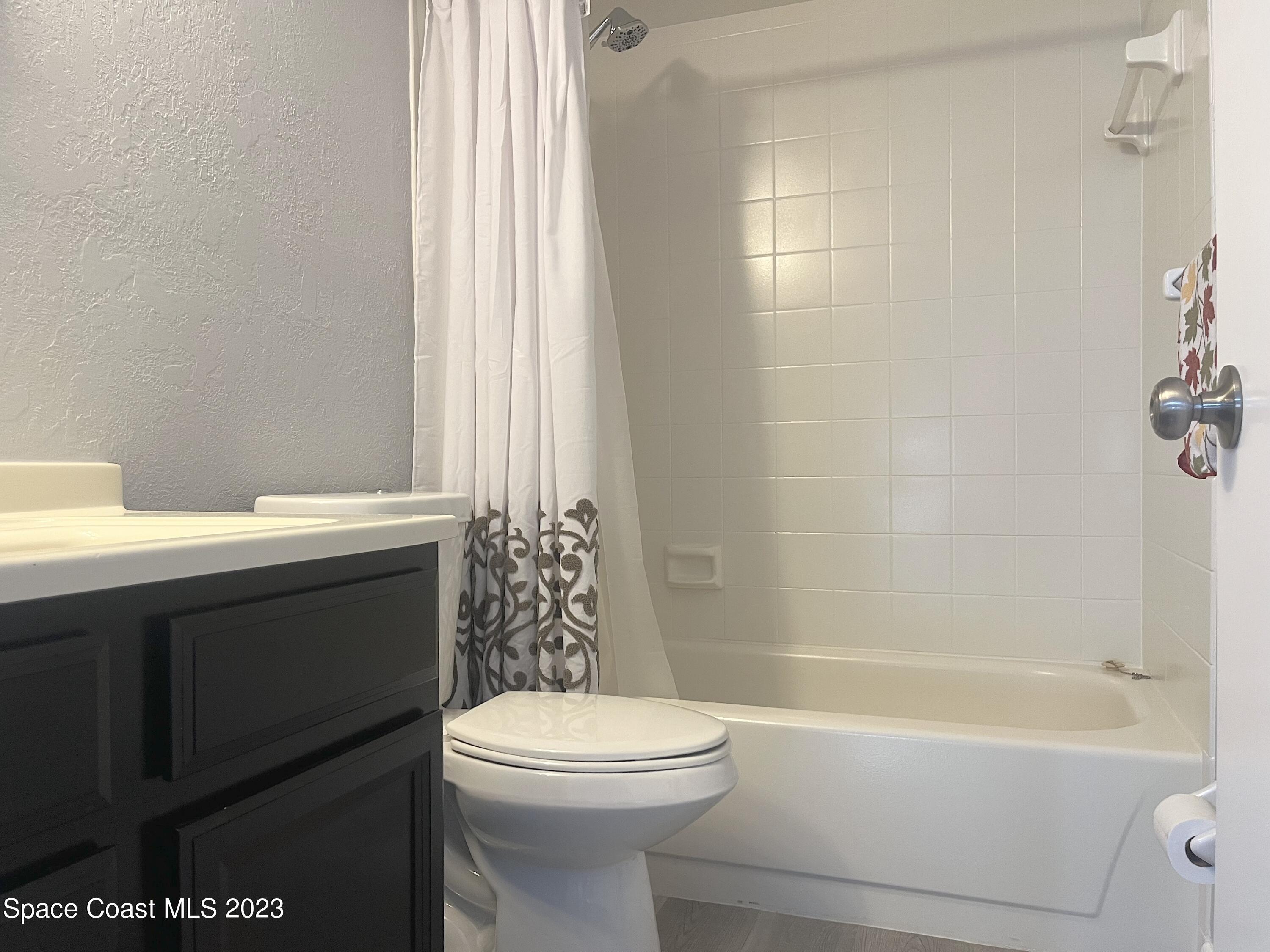 1675 South Fiske Boulevard, Unit 155 Rockledge, FL 32955 - Photo 15 of 24 a bathroom with a sink a toilet and shower