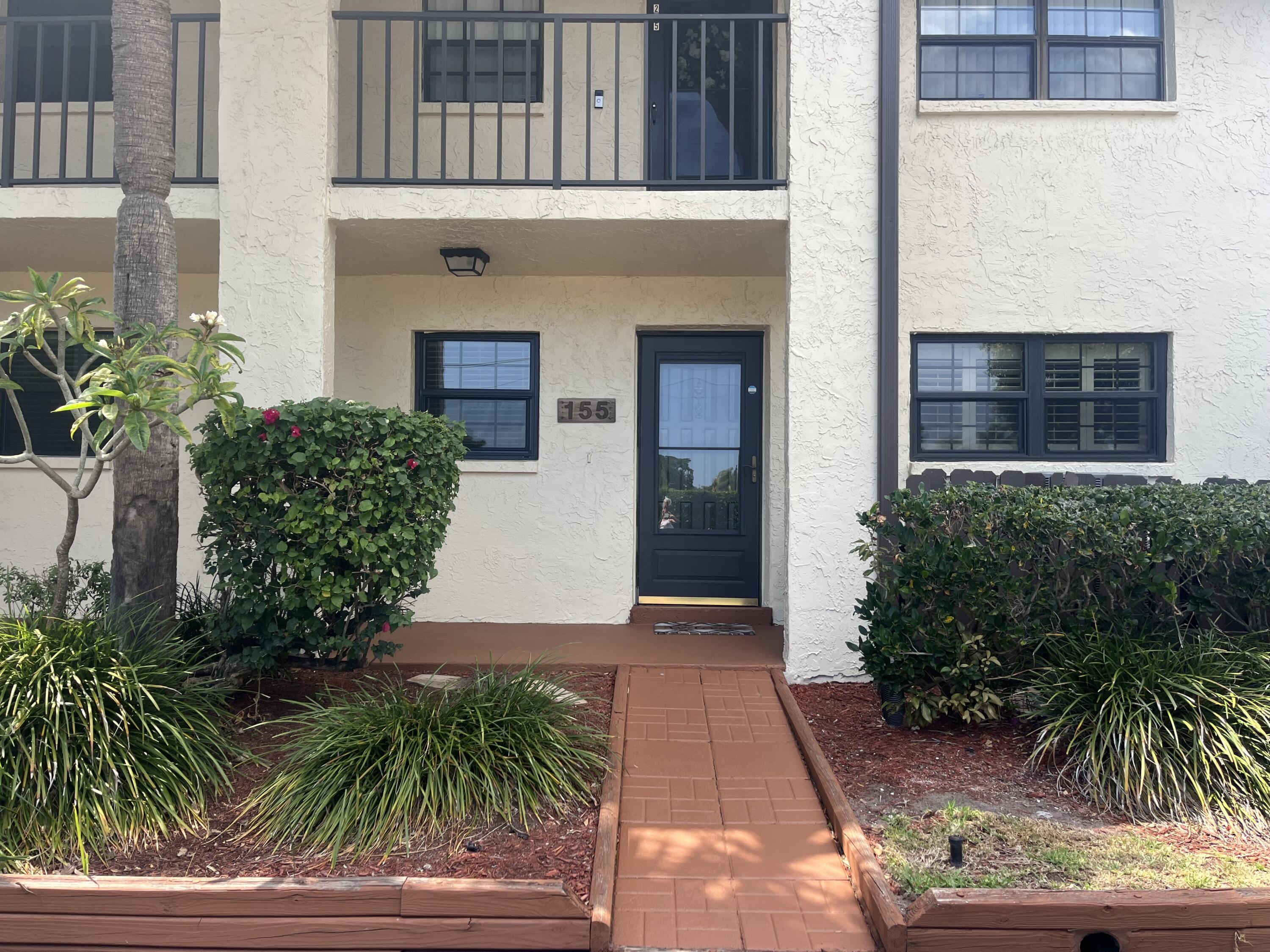 1675 South Fiske Boulevard, Unit 155 Rockledge, FL 32955 - Photo 21 of 24 a front view of a house with plants and entryway
