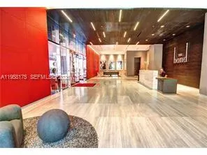 a lobby with furniture and a rug