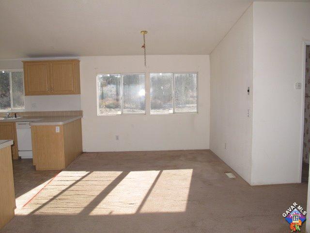 10911 Soledad Road Pinon Hills, CA 92372 - Photo 8 of 25 a view of an empty room with window and chandelier fan