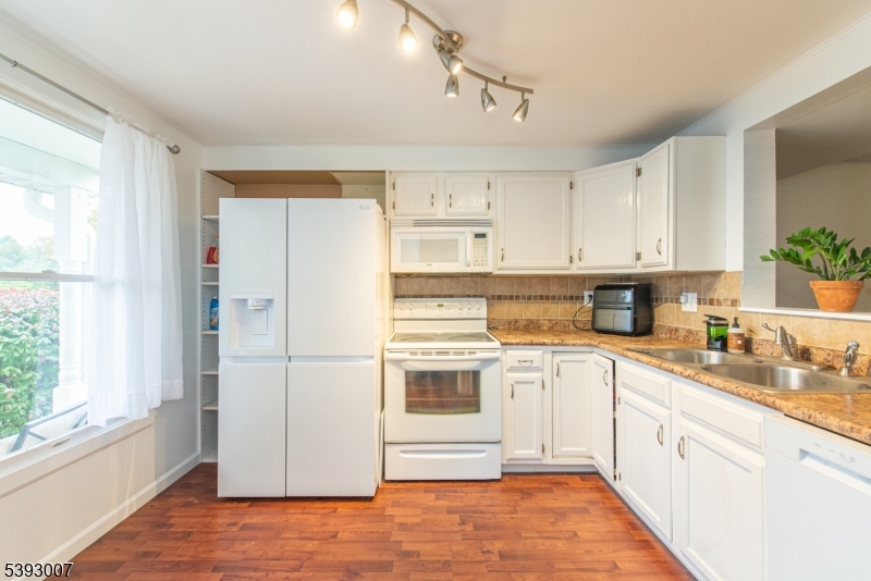 76 Constitution Way, Unit 76 Franklin, NJ 07416 - Photo 4 of 22 a kitchen with stainless steel appliances granite countertop a refrigerator and a stove top oven