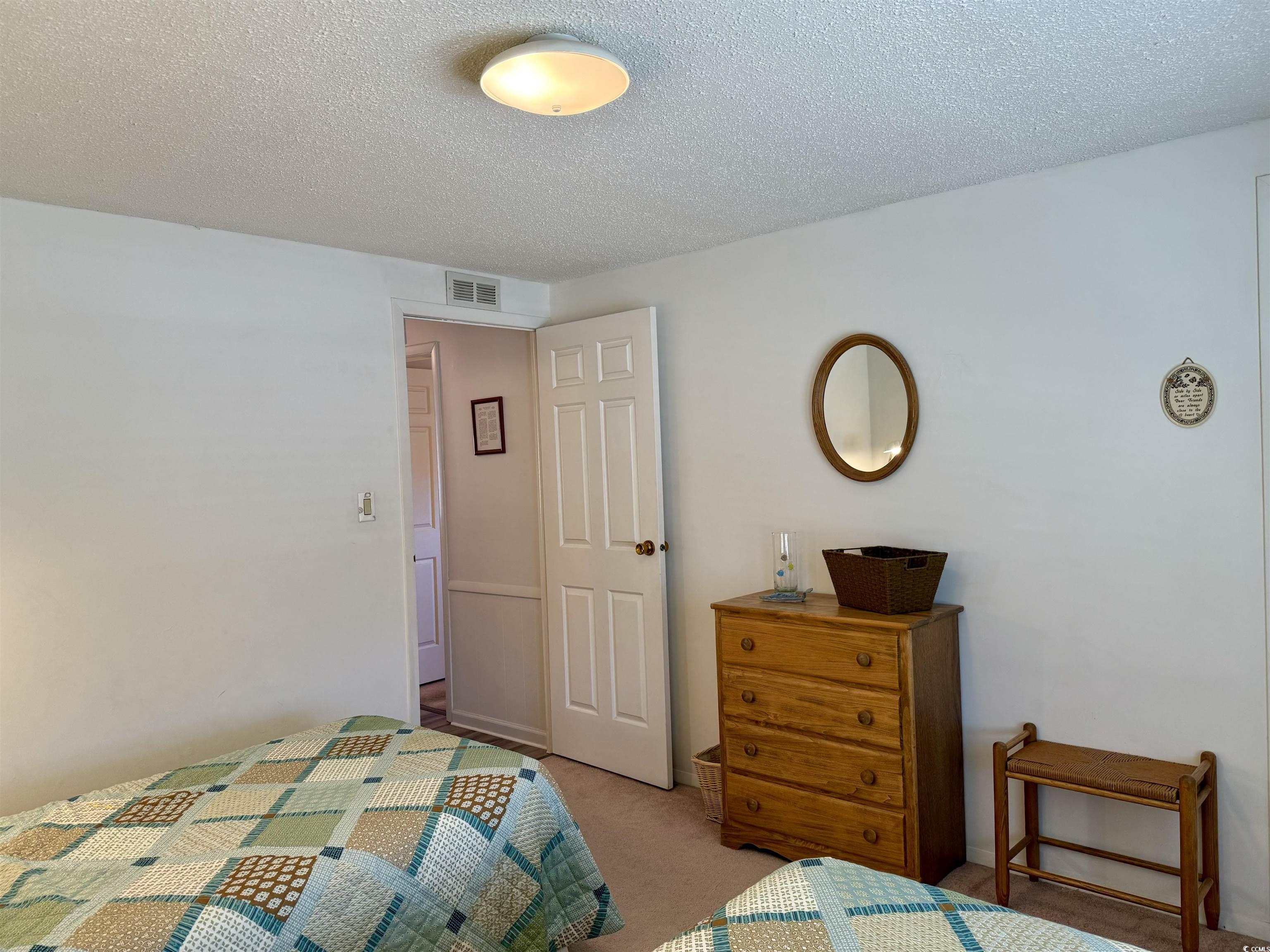 502 Sandpebble Surfside Beach, SC 29575 - Photo 17 of 31 Bedroom featuring a textured ceiling and light col
