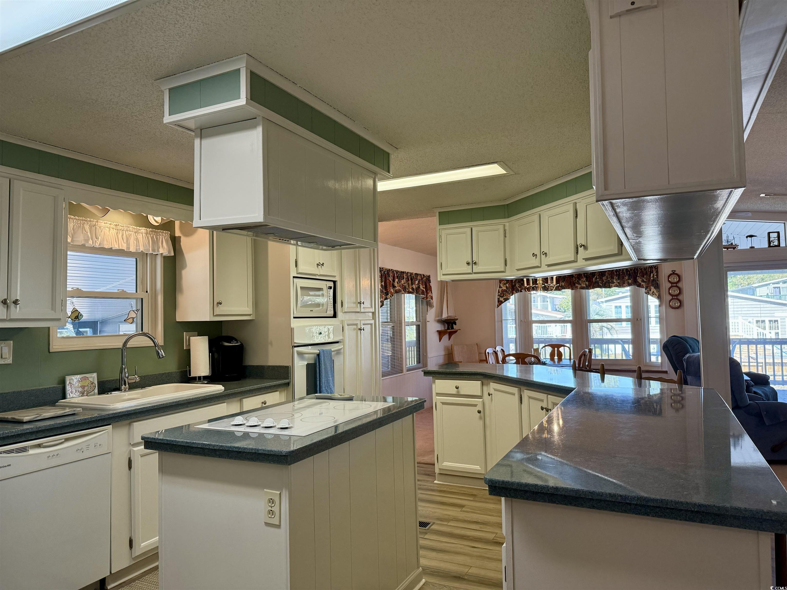 502 Sandpebble Surfside Beach, SC 29575 - Photo 23 of 31 Kitchen with sink, a kitchen island, kitchen penin
